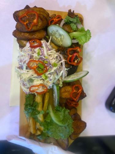 a plate of food with salad and other foods at Ontario Suites in Lagos