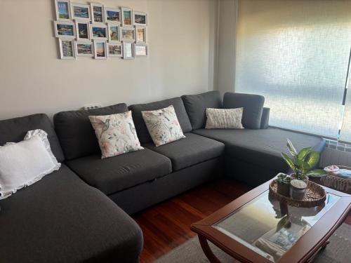a living room with a couch and a coffee table at Beautiful apartment next to the historic center in Vigo