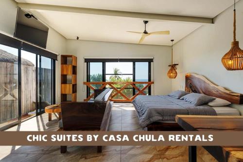 a bedroom with a bed and a couch and a table at Magnifico Loft para 2 con Vista al Mar de Zicatela in Brisas de Zicatela
