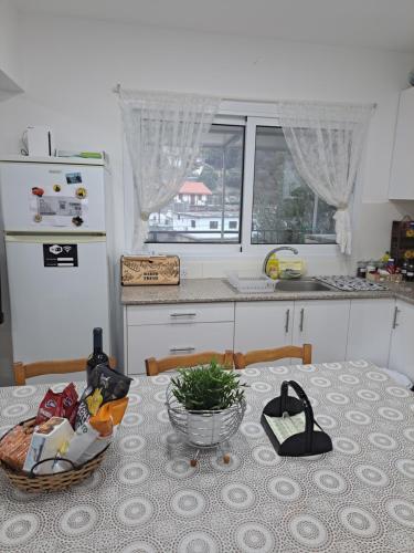 a kitchen with a table with a bowl of food on it at The Heart of Moutoullas in Moutoullas
