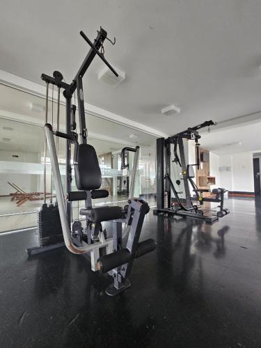 a gym with several tread machines in a room at Loft Centro Oktoberfest - Blumenau in Blumenau