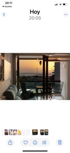 a view of a living room with a couch and a table at Calypso in Cotillo