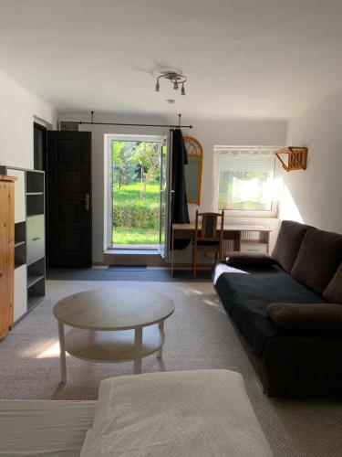 a living room with a couch and a table at Panda apartman in Esztergom