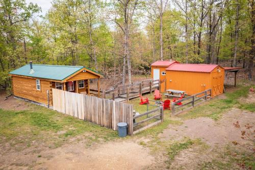 a cabin in the woods with a wooden fence at Timber Ridge Retreat in Morton Grove