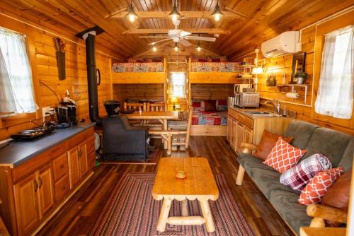 a living room with a couch and a table in a cabin at Timber Ridge Retreat in Morton Grove