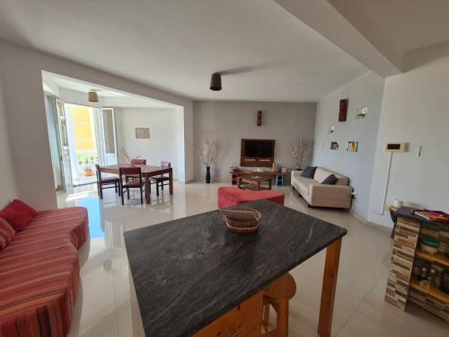 a living room with a couch and a table at Apart Laginha Tess & To in Mindelo