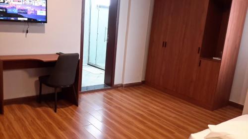 a room with a desk and a chair and a door at Yofel Hotel in Addis Ababa