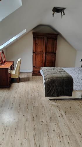 a bedroom with a bed and a desk and a piano at Arthur house in Whitehouse Lower