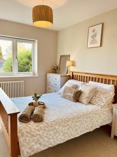 a bedroom with a large bed with two pillows at The Light Keepers Retreat in Cromer