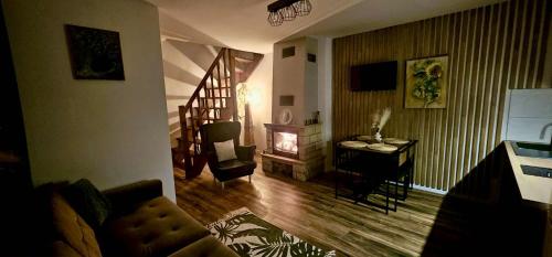 a living room with a couch and a fireplace at Bezdroża Mazurskie in Mrągowo
