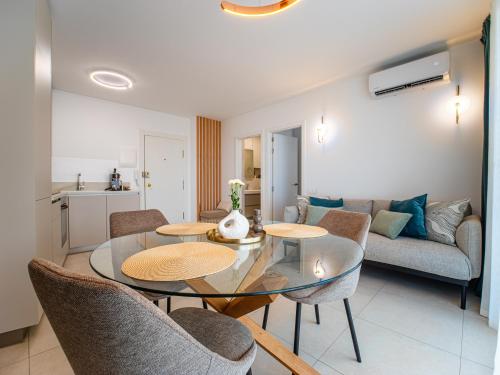 a living room with a table and chairs and a couch at Deluxe Atico Puerto de la Cruz in Puerto de la Cruz