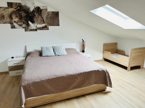 a bedroom with a bed and a sloped ceiling at Große Ferienwohnung Gästehaus NEUBAU Merzig 120m2 in Merzig