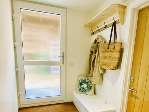 a hallway with a door and a window at The Light Keepers Retreat in Cromer