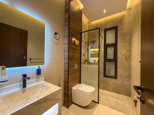 a bathroom with a toilet and a sink and a shower at The Square One in Jeddah