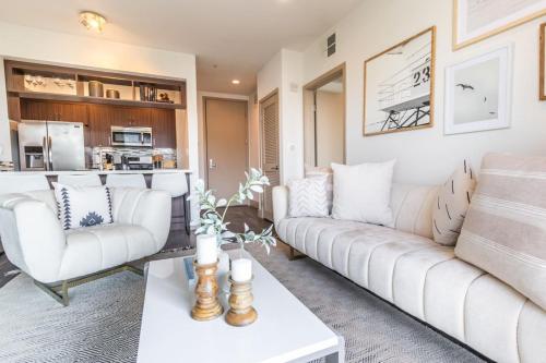 a living room with two white couches and a table at Trendy 2BD 2BTH Apt steps from Downtown Santa Monica! in Los Angeles