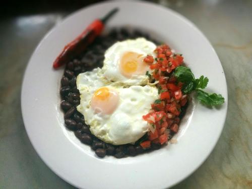 a plate of food with eggs and beans at Hotel Casa San Pancho in San Francisco