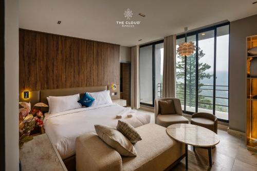 a hotel room with a bed and a couch at The Cloud Xpress in Nathia Gali