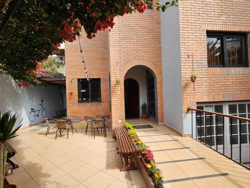 a patio with a bench in front of a building at Haku Hostel in Lima