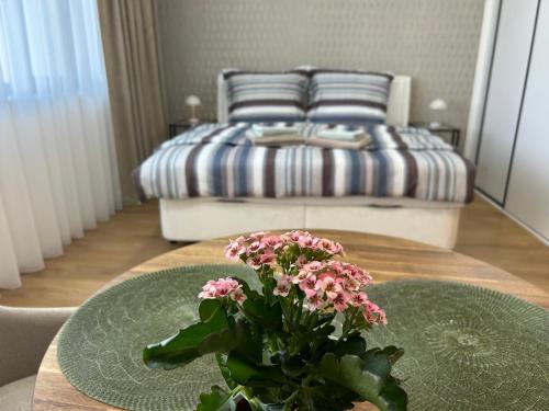 a room with a table with a bed in the background at Apartmány Klement in Znojmo