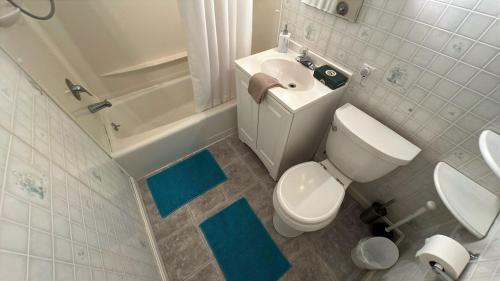 a white bathroom with a toilet and a sink at Water's Edge in Bucksport