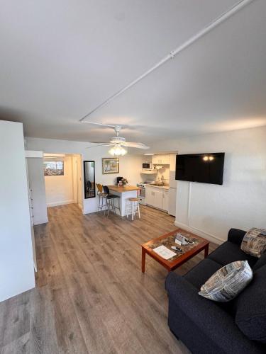 a living room with a couch and a table at Coral Key Inn in Fort Lauderdale