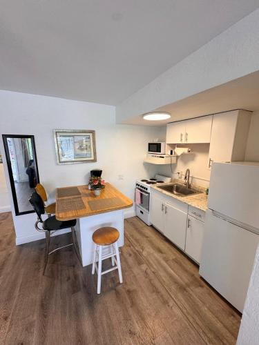 a kitchen with a table and a counter top at Coral Key Inn in Fort Lauderdale