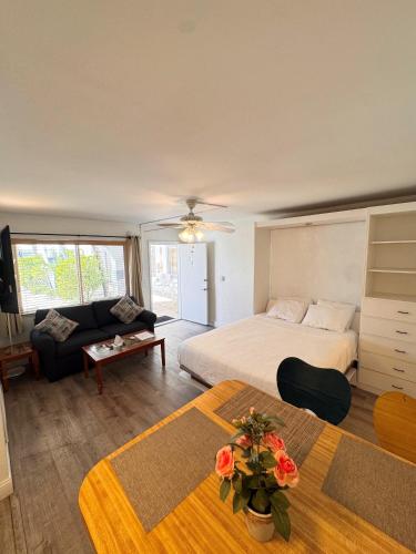 a hotel room with a bed and a couch at Coral Key Inn in Fort Lauderdale