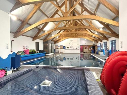 a large indoor swimming pool in a building at Modern Caravan 2025 with Decking in Morecambe