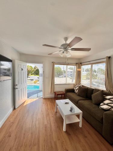 a living room with a couch and a table at Coral Key Inn in Fort Lauderdale