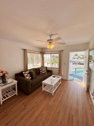 a living room with a couch and a table at Coral Key Inn in Fort Lauderdale