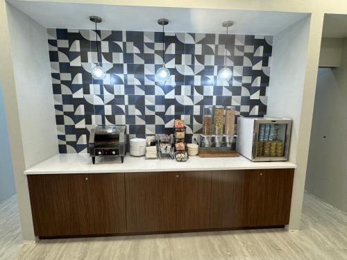 a coffee shop with a black and white checkered wall at La Quinta by Wyndham New Haven in New Haven