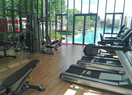 a gym with cardio machines and a swimming pool at Eve Suite in Petaling Jaya