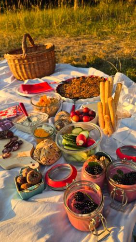 a table with a bunch of food on it at Kdebolotambolo chalupka in Belá