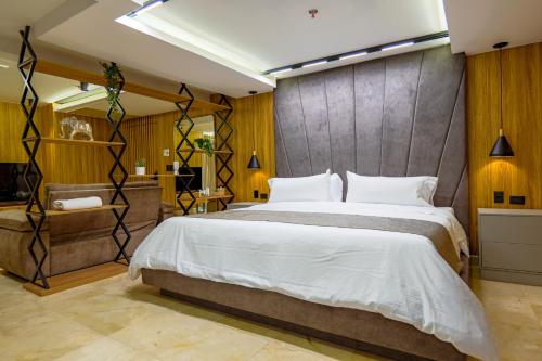 a bedroom with a large bed and a bathroom at Del Mar City View in Cartagena de Indias
