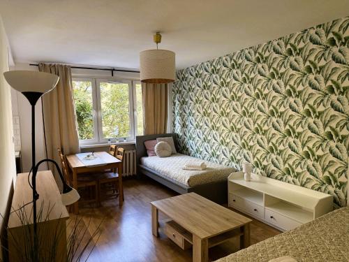 a living room with a couch and a table at Justinrent Piekarska in Legnica