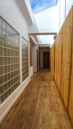 um corredor de um edifício com pisos de madeira e uma clarabóia em A Casa del Rei em Ribeira Grande
