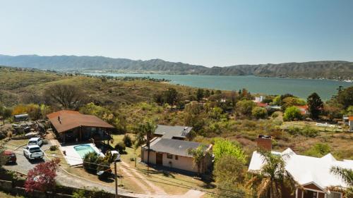 an aerial view of a house and a lake at EL PALMAR in Villa Carlos Paz