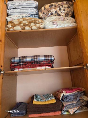 a closet filled with lots of clothes and towels at Leila in Agadir