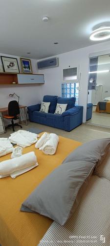 a living room with a couch and a bed at Suite solarium Km21 in Vera