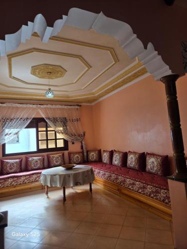 a living room with a red couch and a table at Leila in Agadir