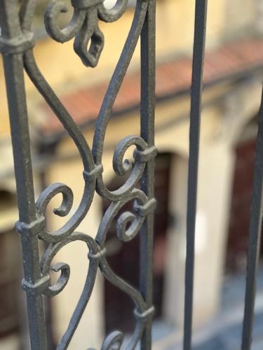 an iron gate with a building in the background at Cuore di Agrigento Home in Agrigento