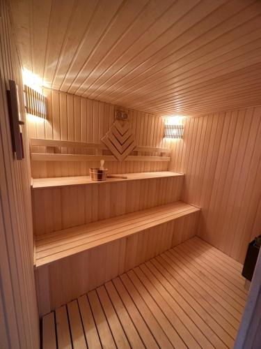 a sauna with wooden shelves and lights in it at NatureNest A-Frame Cabin in Gabala
