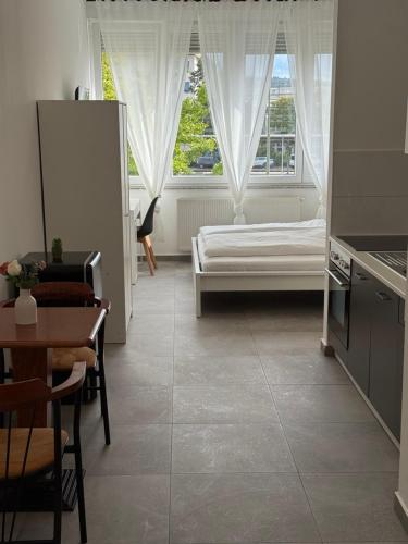 a living room with a bed and a table at Ok Apartments in Pforzheim
