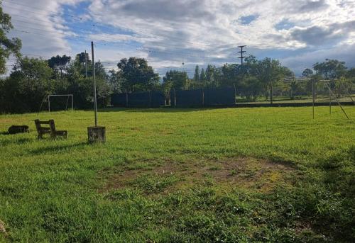 a park with a bench in the middle of a field at La Fonda de Jorge in Rosario de Lerma