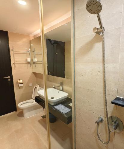 a bathroom with a sink and a toilet at Hatten Hotel Super Sea View 4pax Mid Floor in Melaka