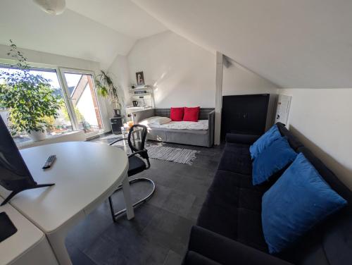 a living room with a couch and a table at Zimmer "Ölberg" im Siebengebirge in Königswinter