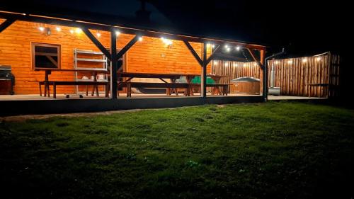 a house lit up at night with lights on it at Agroturystyka Noclegi Podlesie in Gorlice