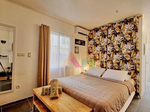 a bedroom with a bed and a large window at Studio cosy à 2 min de la plage, Grand Case - FR-1-734-36 in Grand Case