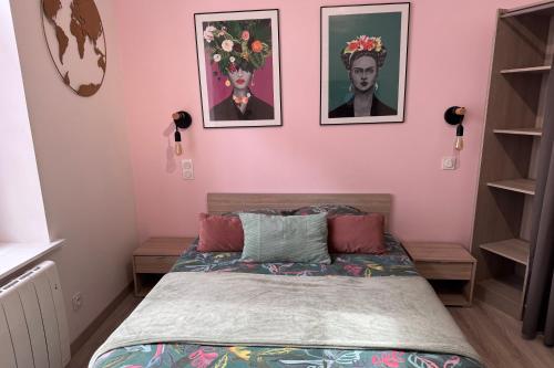 a bedroom with a bed with two pictures on the wall at Beau Studio Neuf proche du centre et de Nausicaa in Boulogne-sur-Mer
