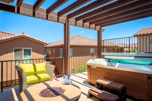 a patio with a hot tub and a table and a deck with at Red Rock Hideaway Family Home with Casita in Ivins